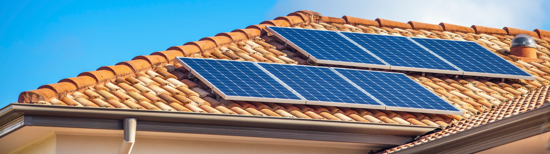 Solar panels attached to a tile roof