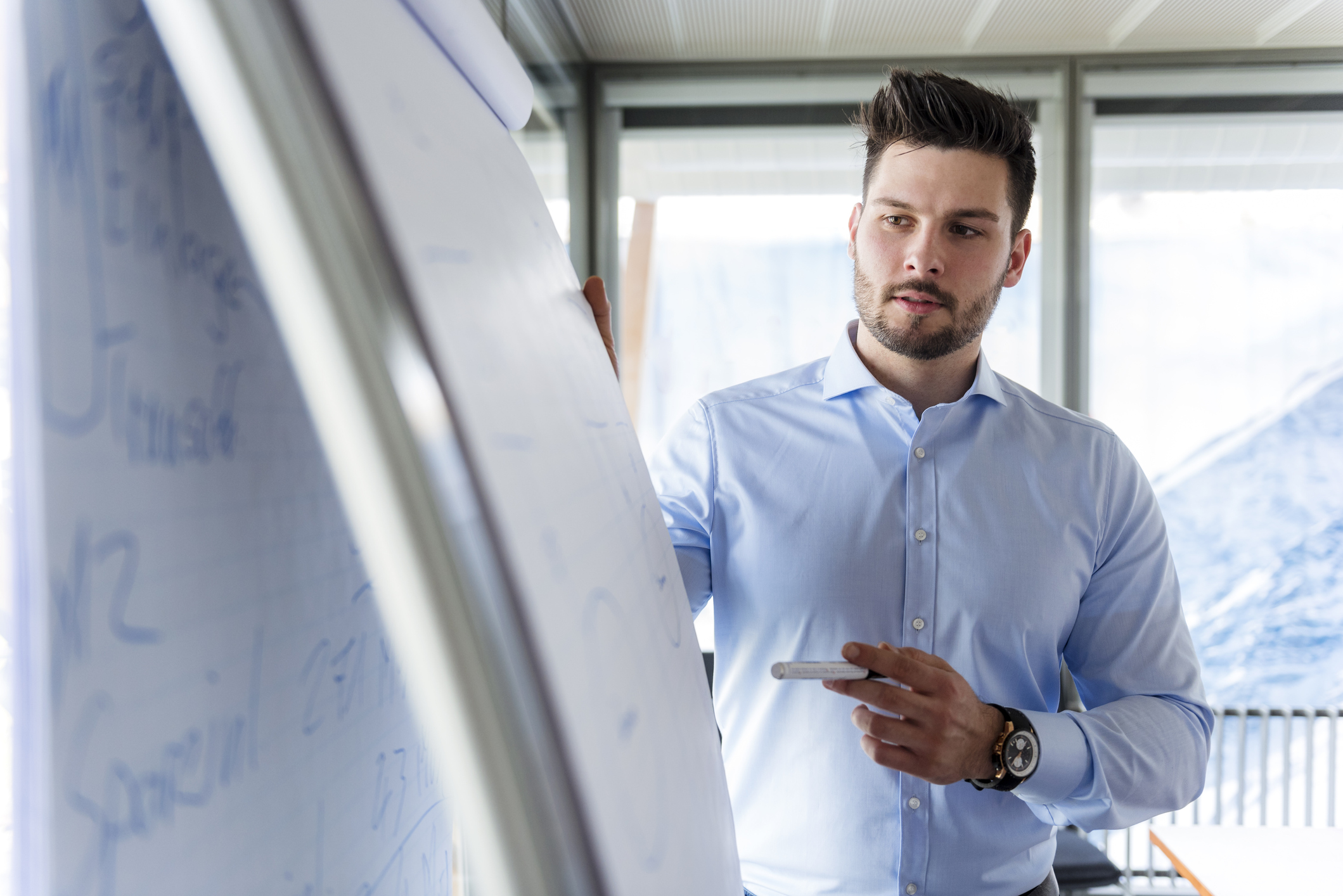 A man looking at a flipchart