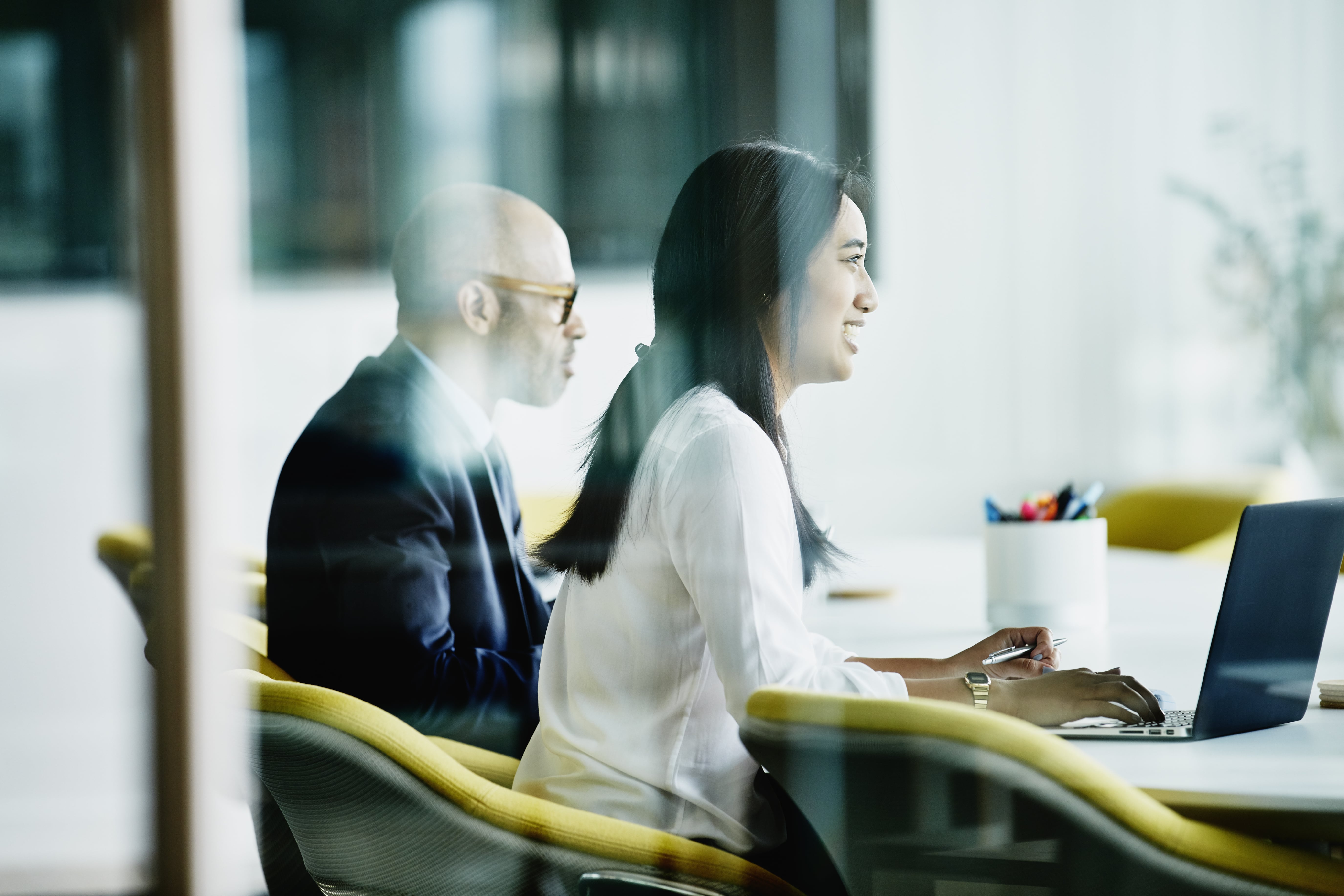 A man and a woman in profile in a meeting