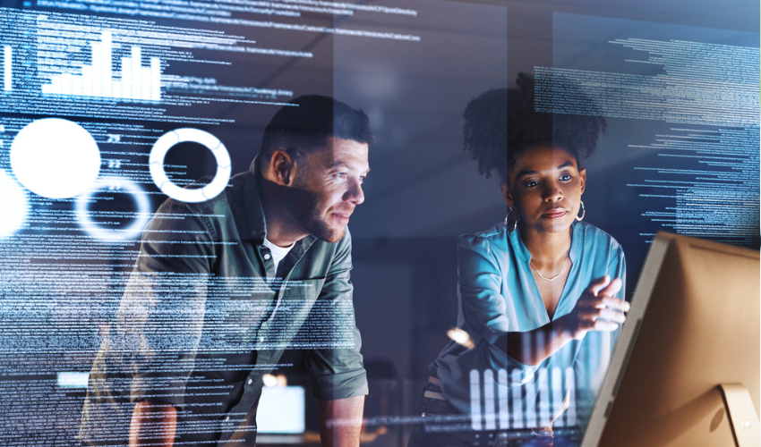 Two colleagues looking a data on a screen