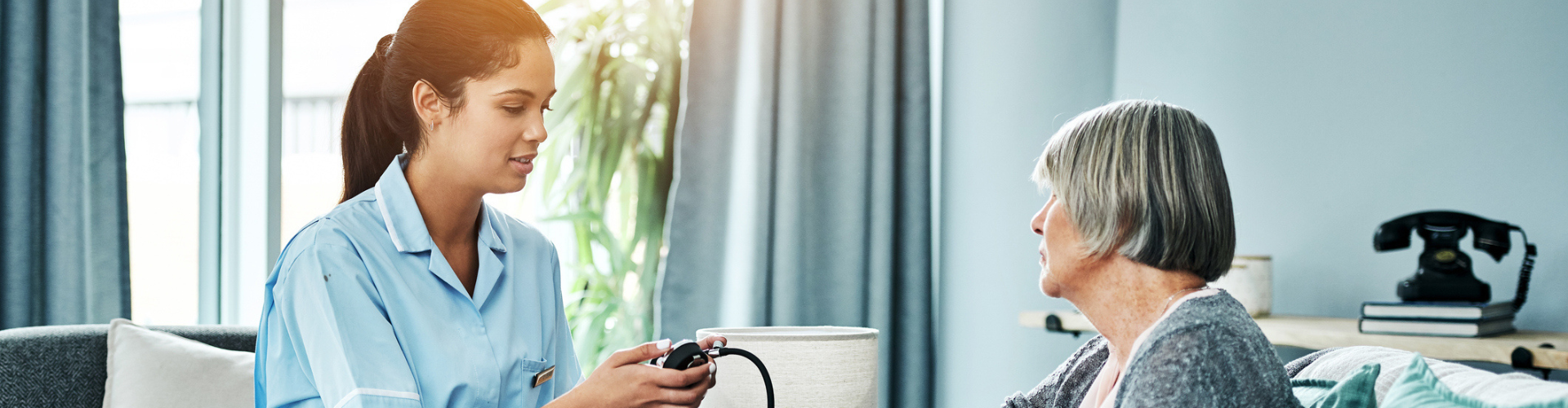 Home nurse checking a patient's blood pressure