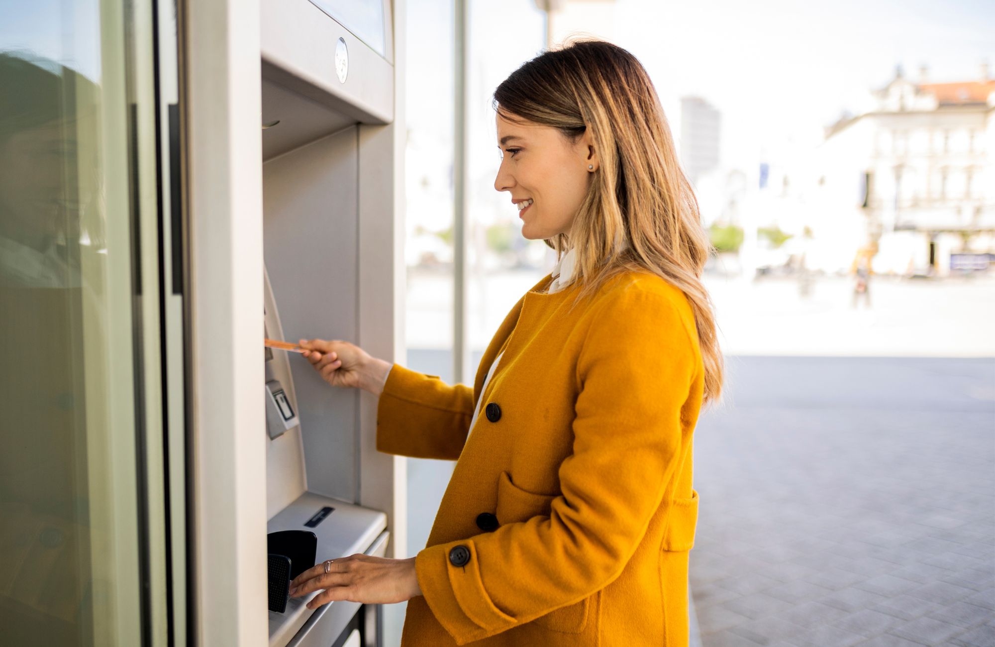 Woman using ATM machine