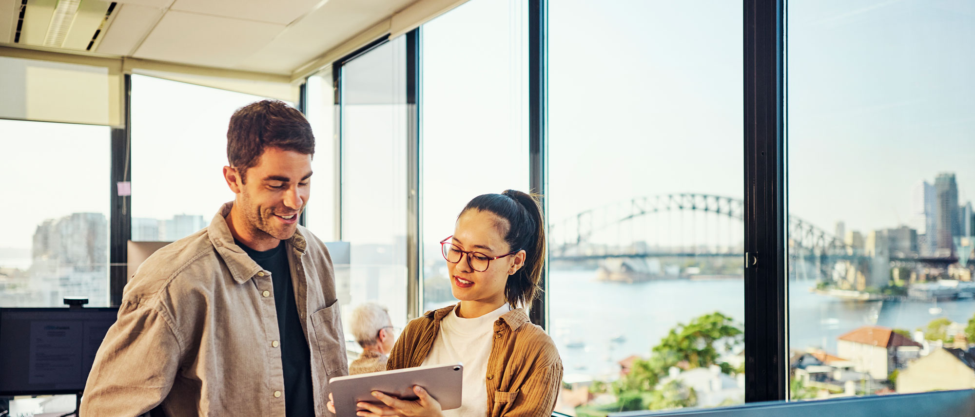 Two people looking at a tablet in a Sydney office