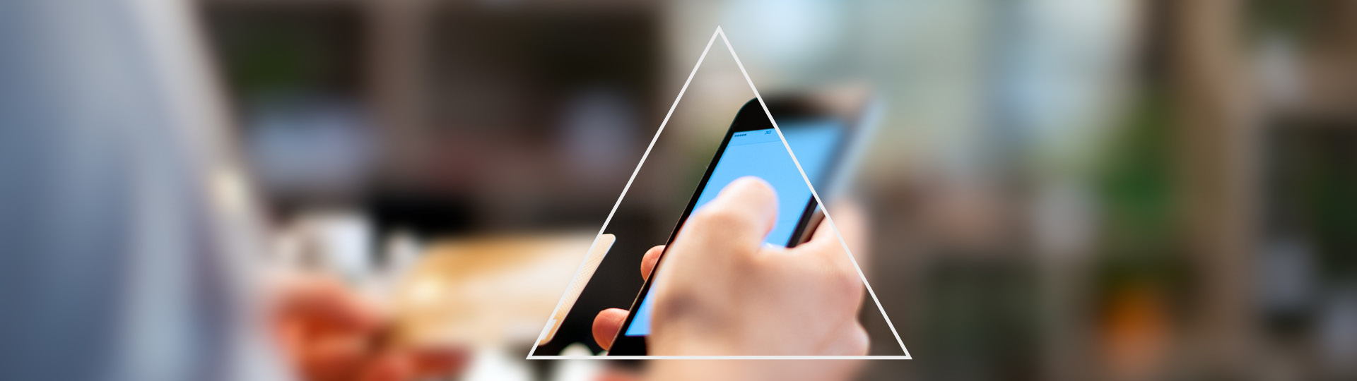 Looking a triangle to see a phone with rest of the image blurred