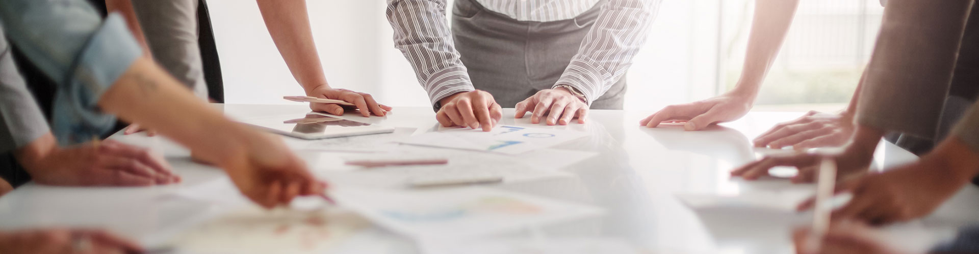 People around a table looking at documents
