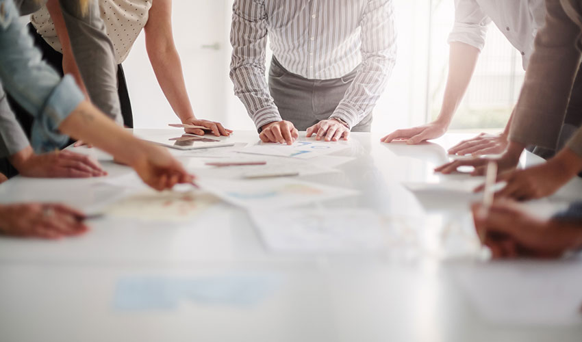 People around a table looking at documents