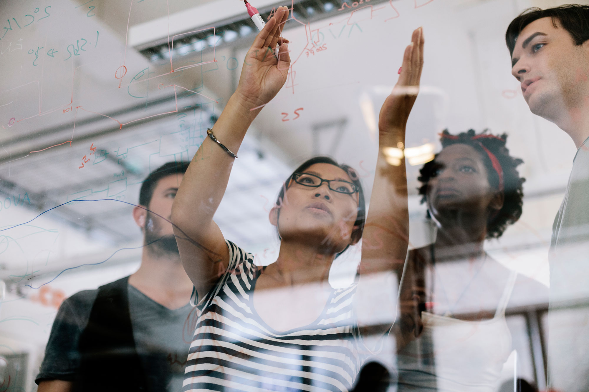 Group of people looking at a board