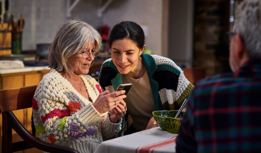 Two women looking at a mobile phone