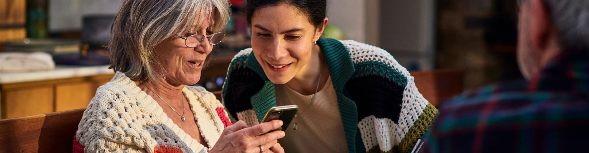 Two women looking at a mobile phone