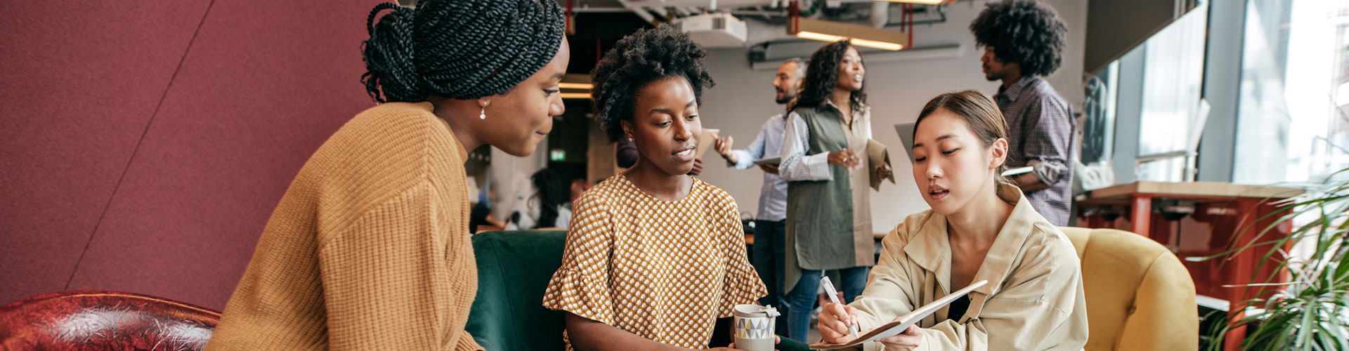 Three people having a discussion in the office