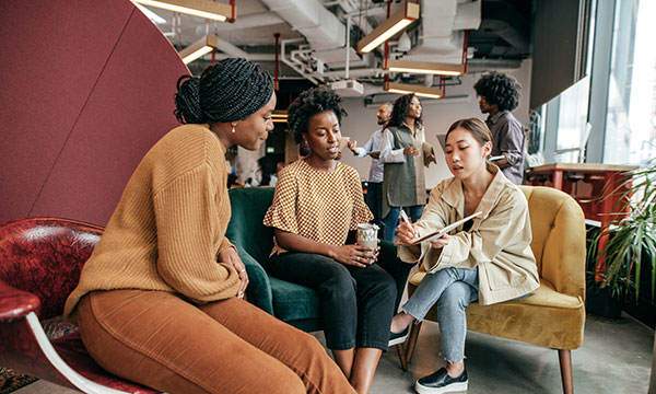 Three people having a discussion in the office
