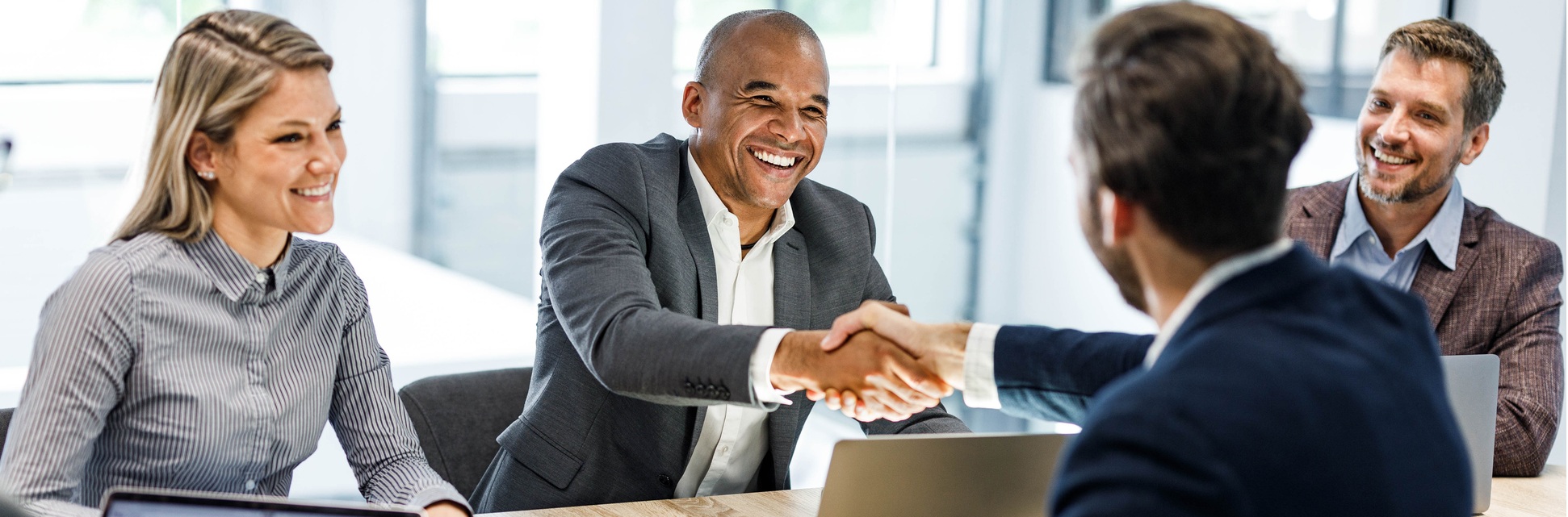 People in a meeting shaking hands