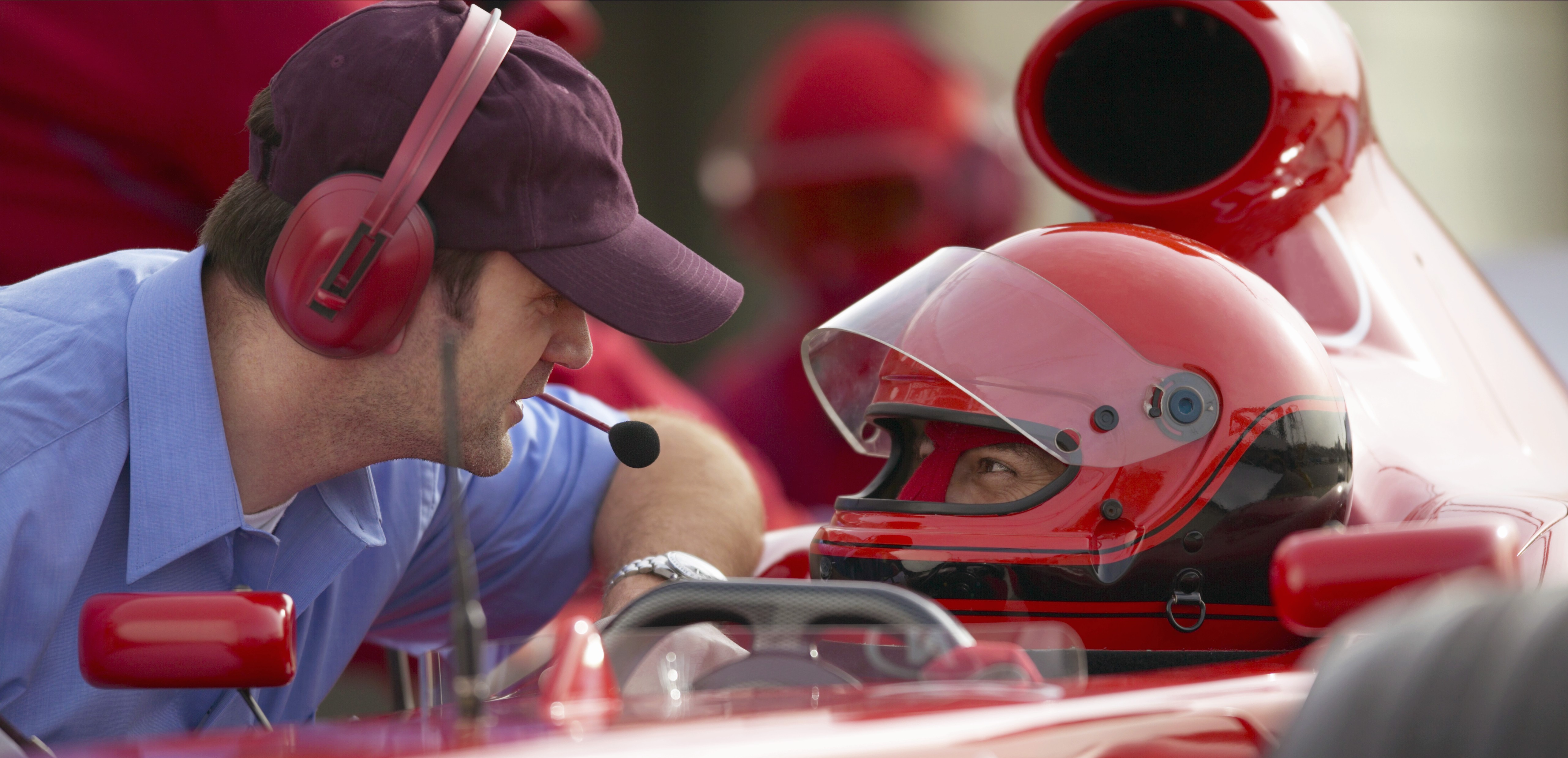 man talking to race car driver