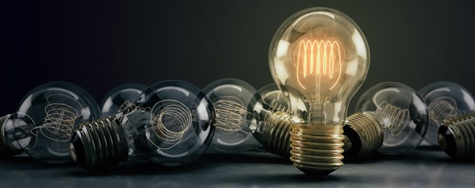  A collection of lightbulbs with one illuminated