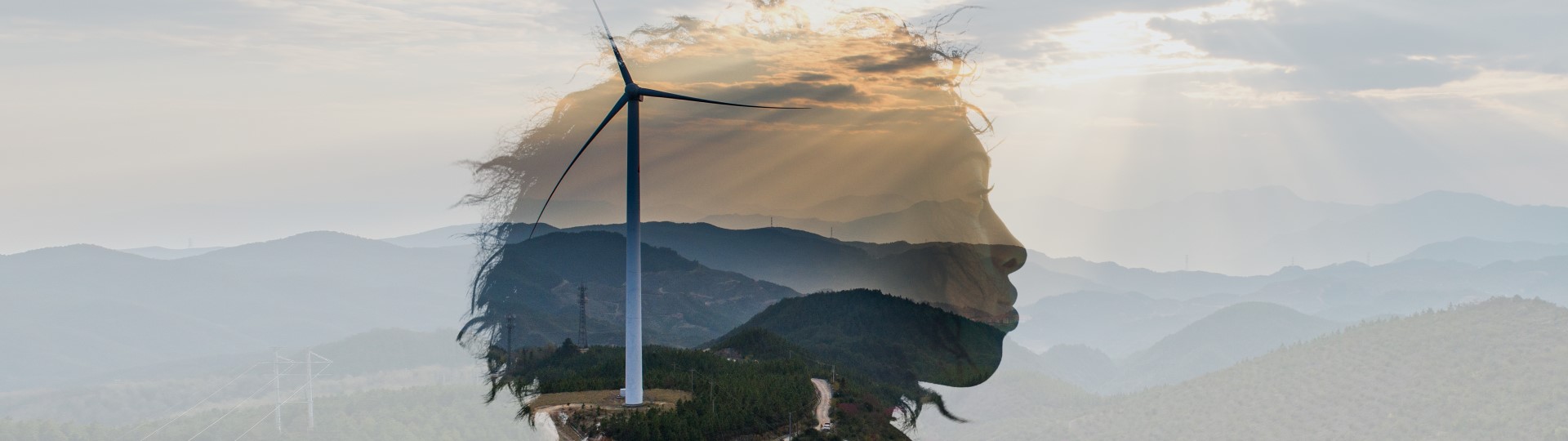 A woman's head superimposed over hills with a wind turbine