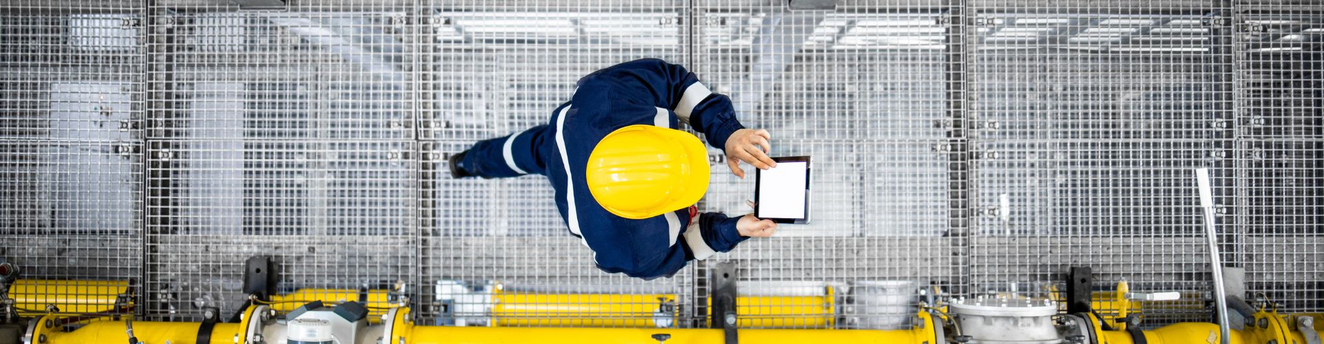 Worker walking on a metallic footbridge