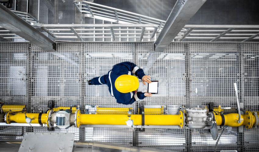 Worker walking on a metallic footbridge