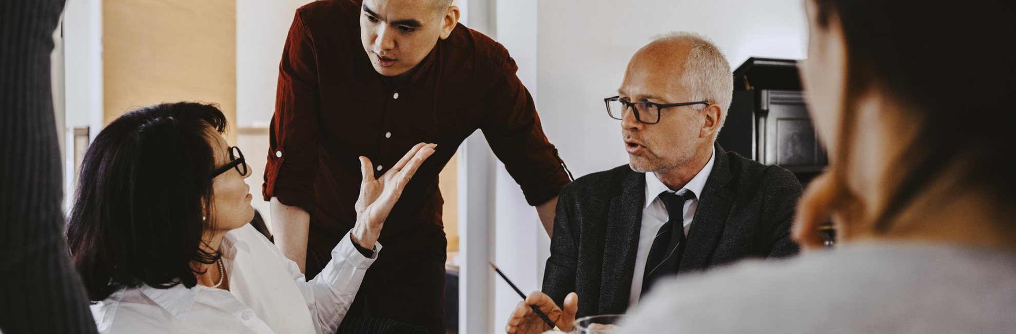 Three people talking during a meeting