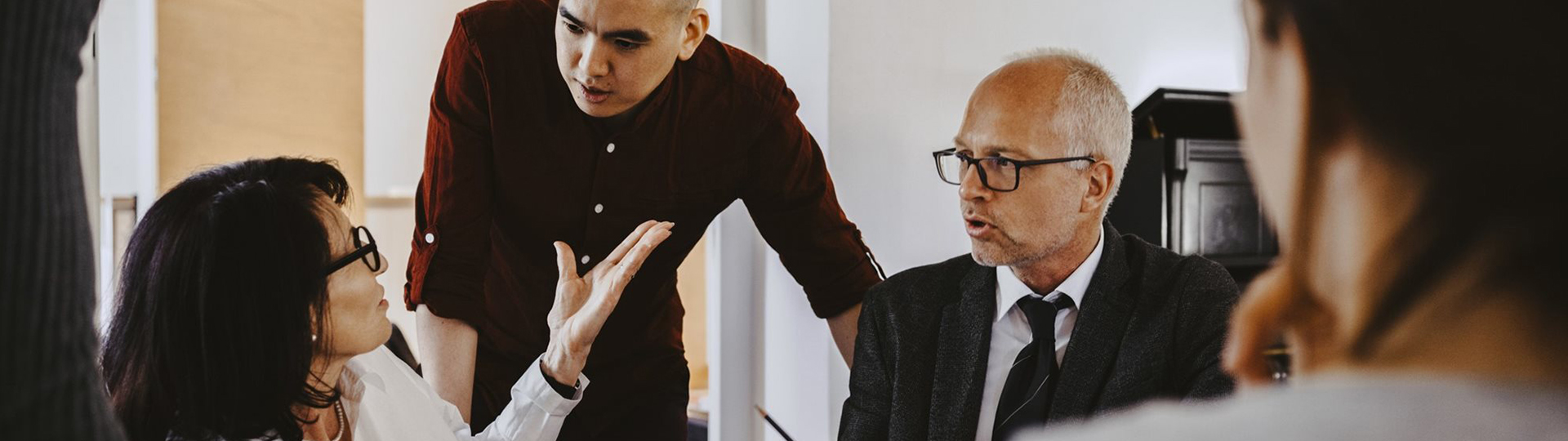 Three people having a discussion during a meeting