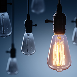 A collection of light bulbs with one illuminated