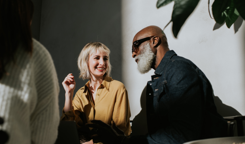 Conceptual image of a man and a woman sitting side-by-side in a sunny, modern environment