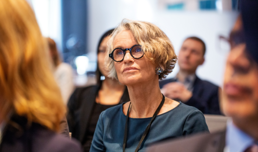 Senior business woman with glasses looking into distance