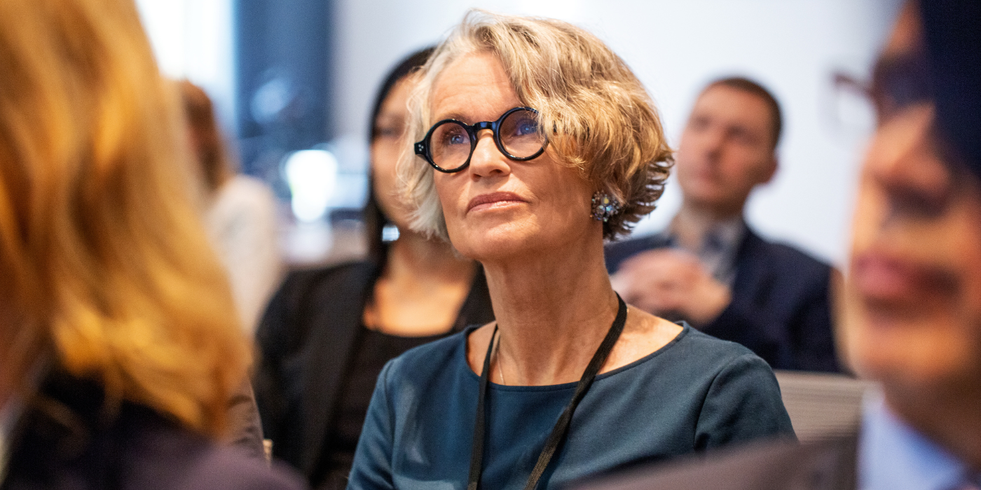 Senior business woman with glasses looking into distance