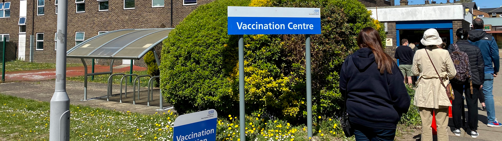 People queueing outside an NHS vaccination centre