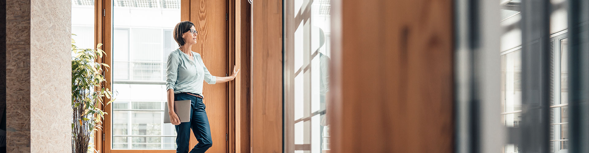 Standing woman opening a door