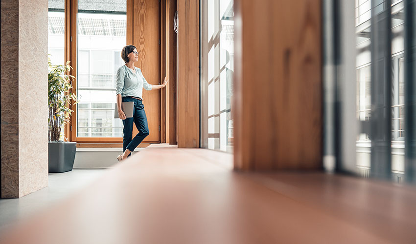 Standing woman opening a door