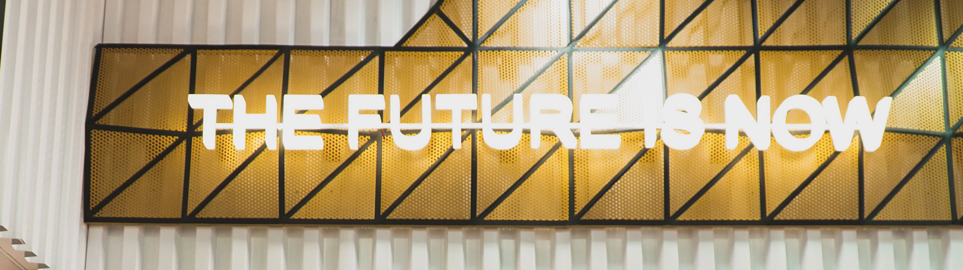 An illuminated sign with the slogan 'The Future Is Now'