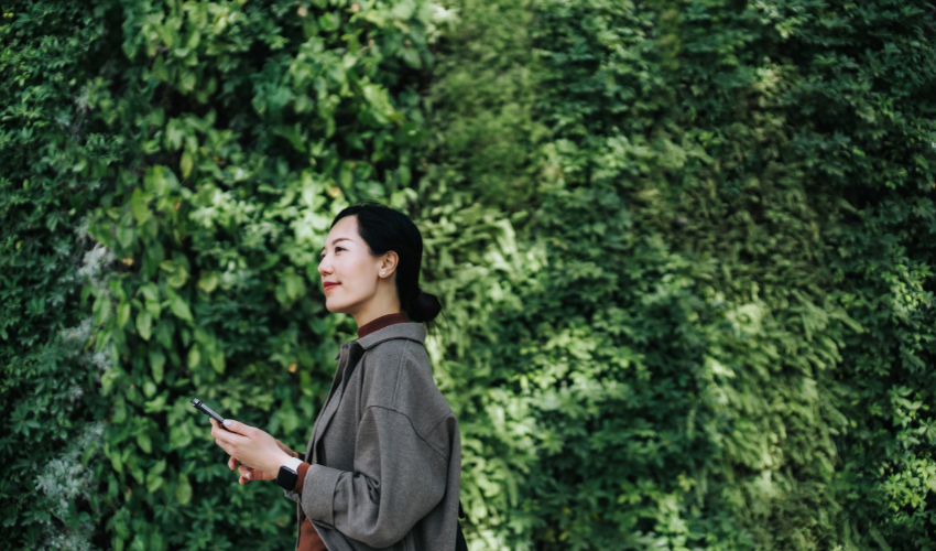 Business woman in front of trees