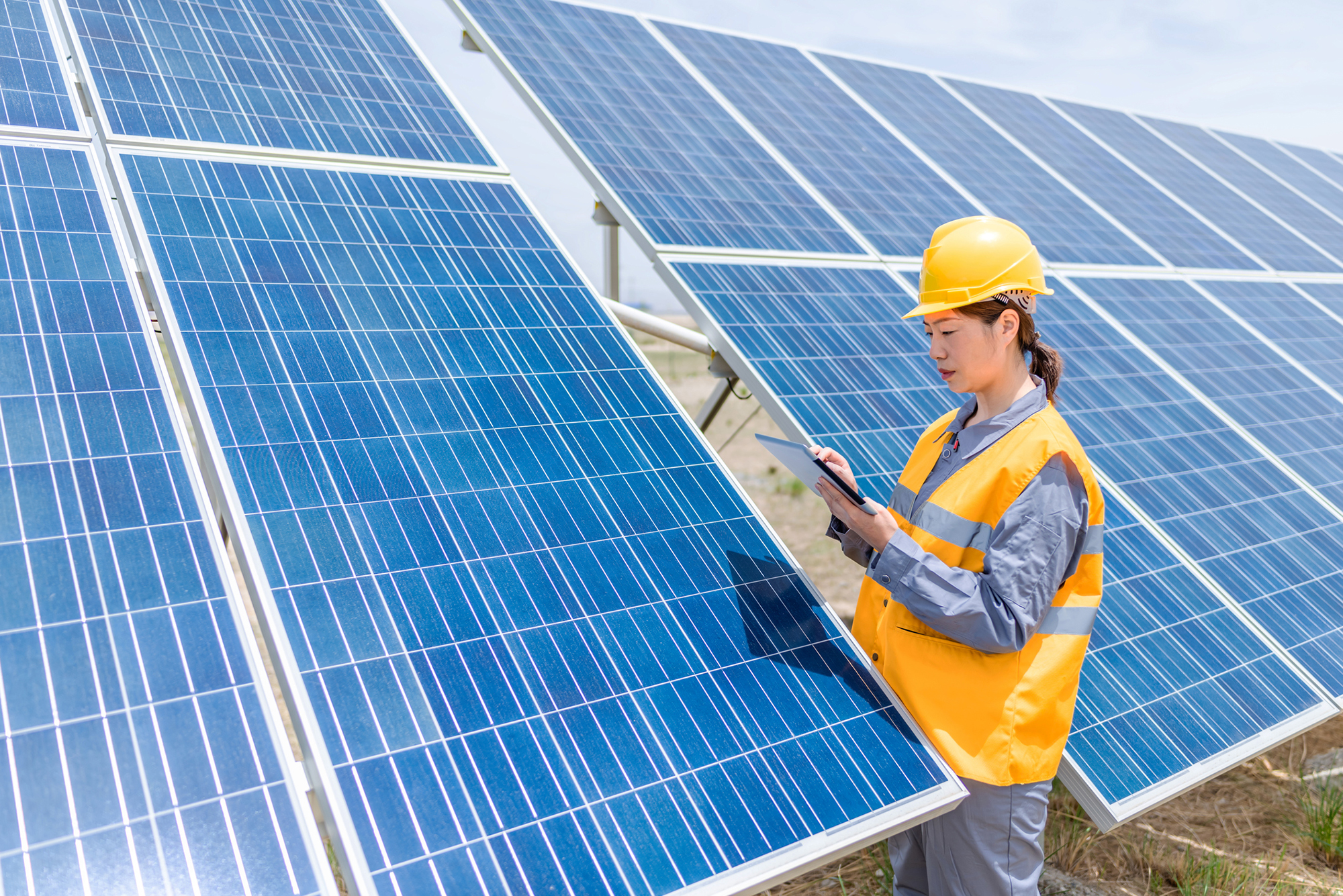Woman working on solar panels