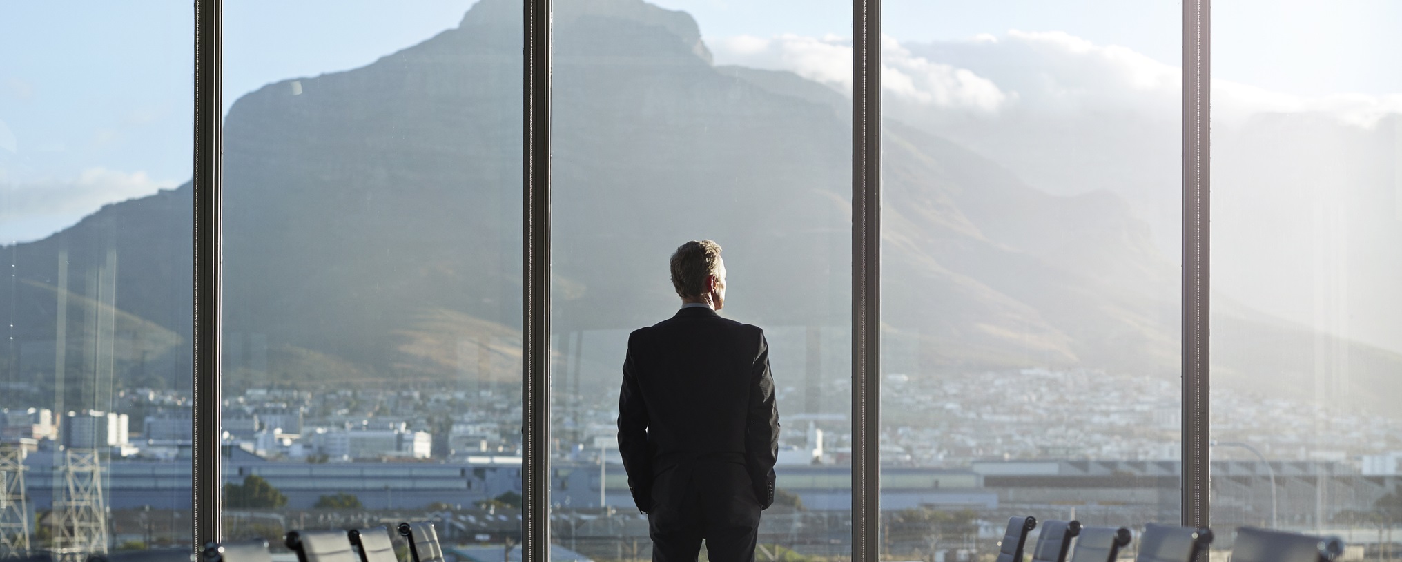 business man in office looking at view