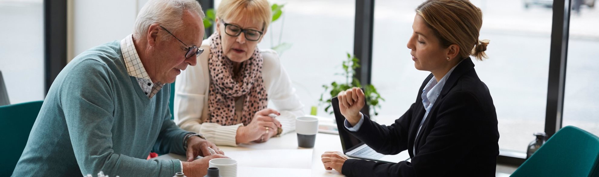 An advisor talking to an elderly couple