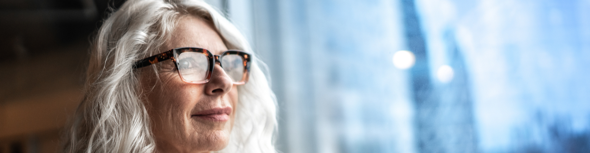 Mature business woman looking out window