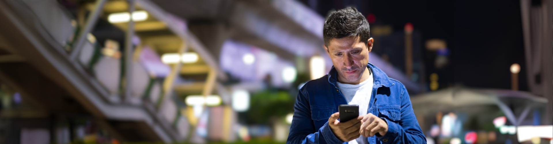 Man looking at his smartphone on the street