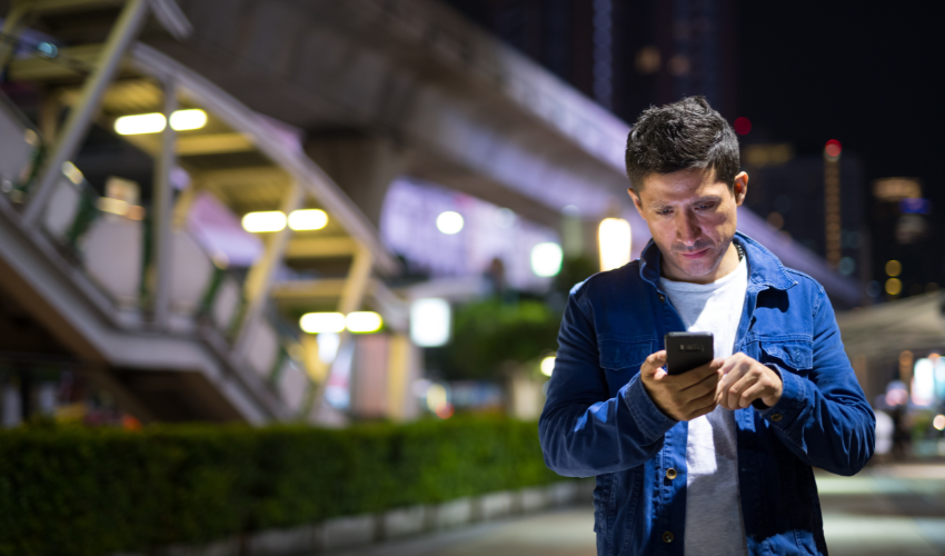 Man looking at his smartphone on the street