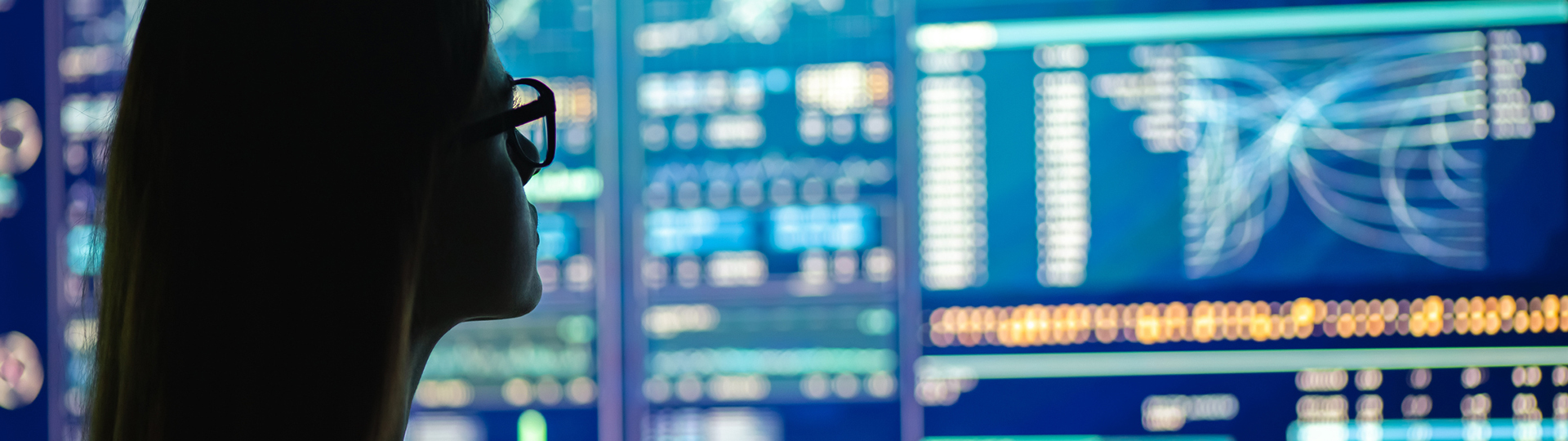 A woman looking at digital screens