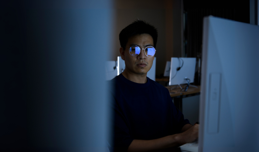 Computer hacker stealing information with computer