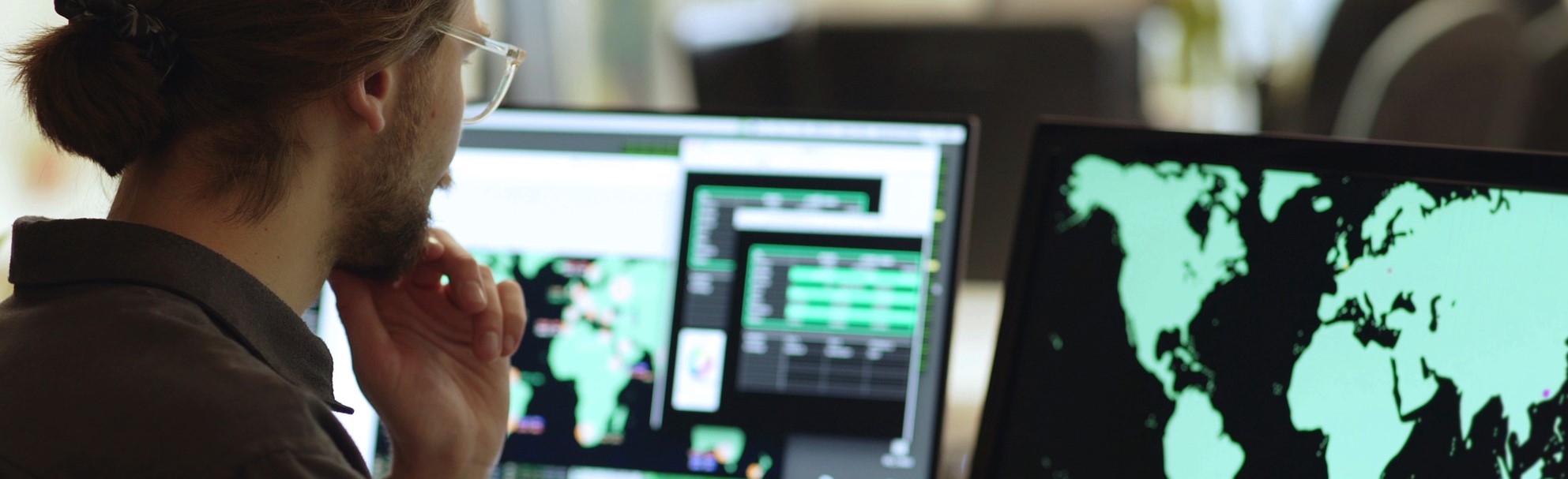 A man viewing a world map on a screen 
