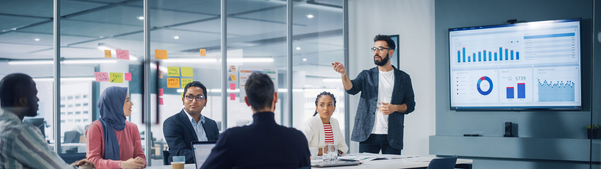 A meeting with a man standing up giving a presentation