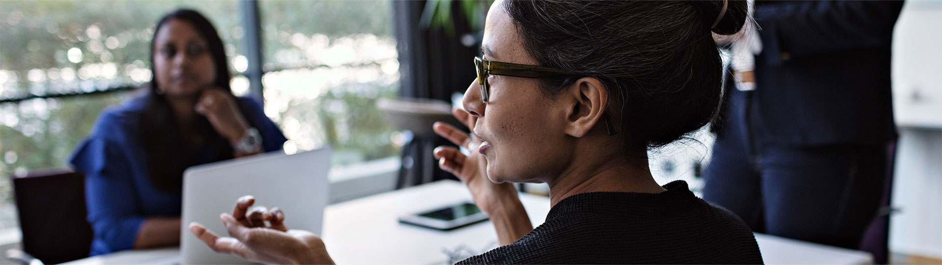 A woman in conversation with a colleague
