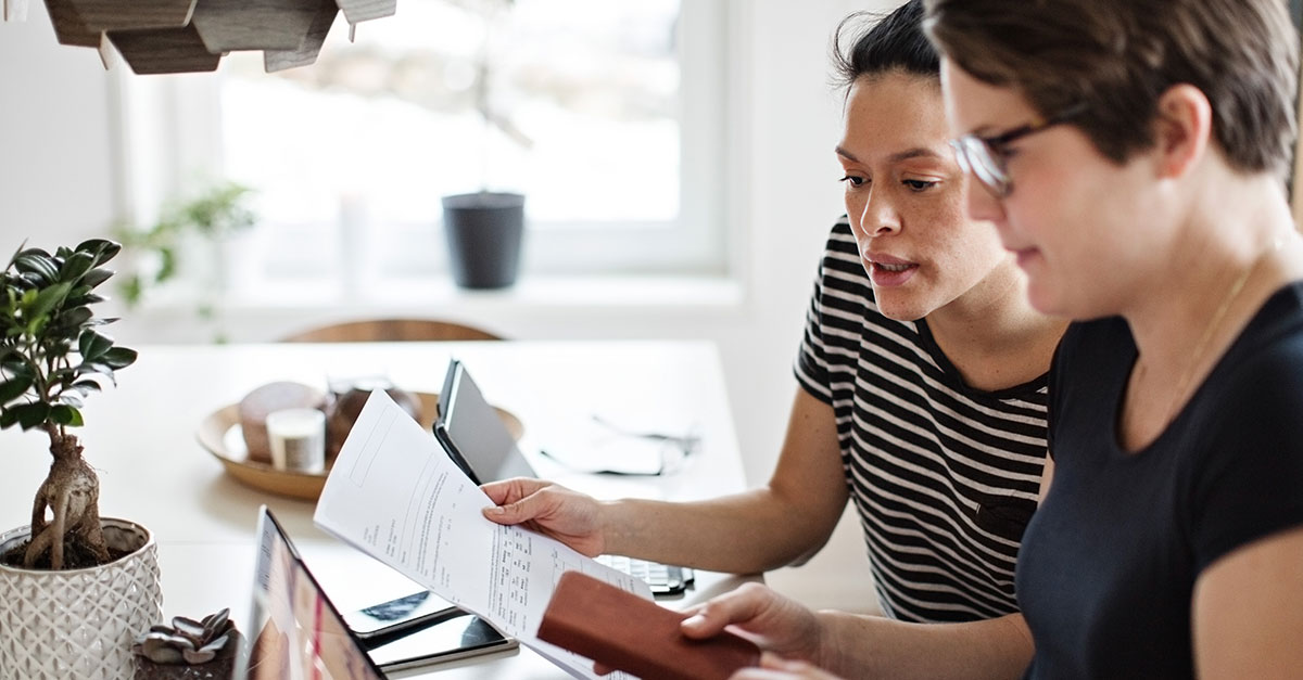 Two people looking at a report