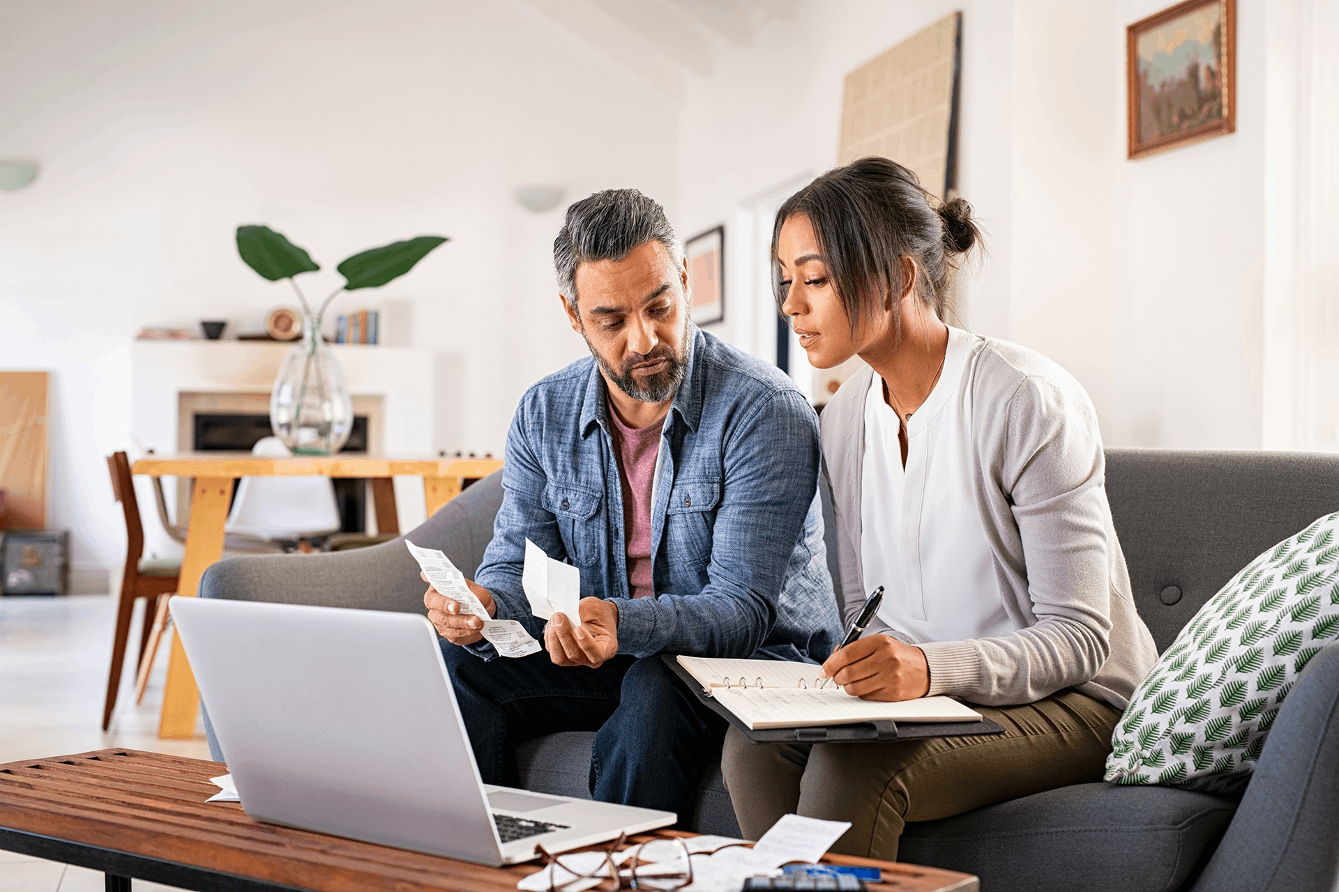 A woman and a man looking at receipts and bills