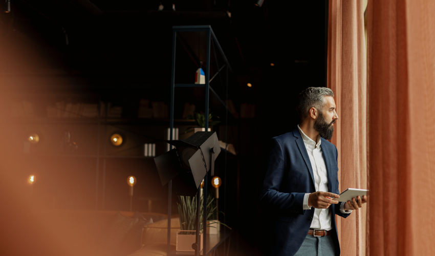 Businessman in cafe holding digital tablet