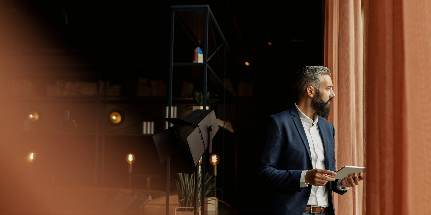 Businessman in cafe holding digital tablet