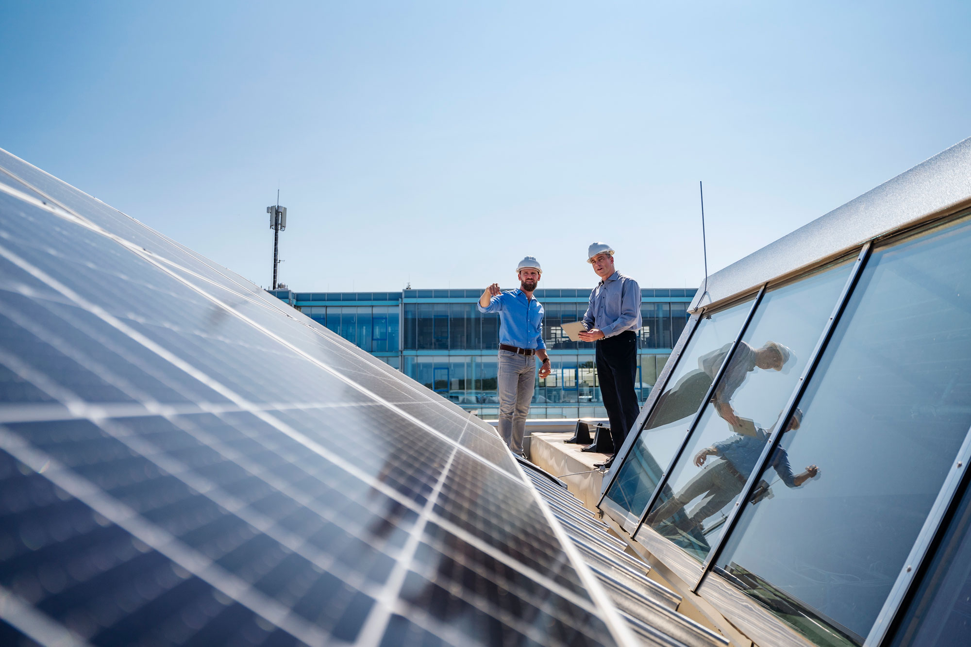Two engineers inspecting a solar panel