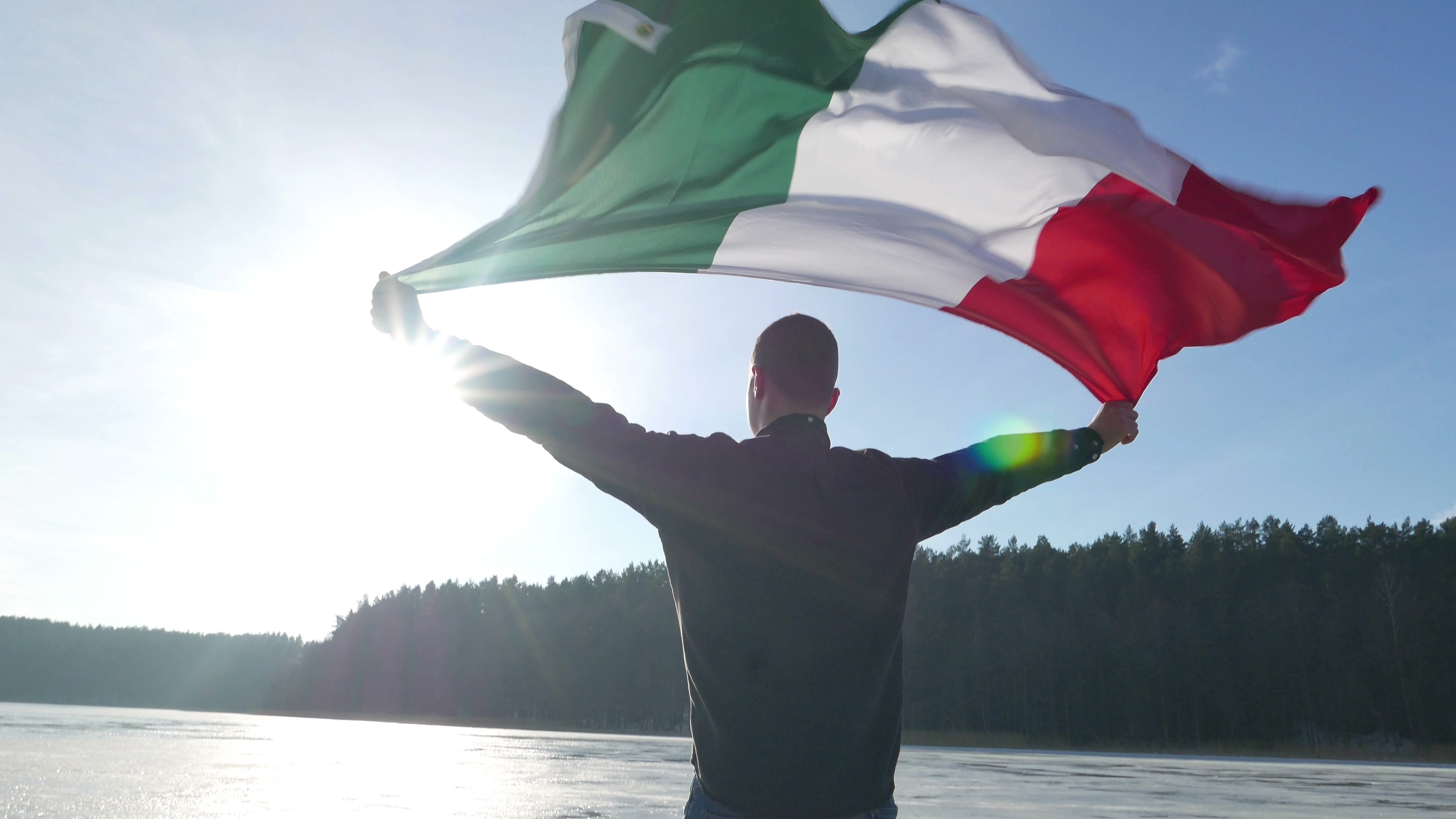 Man holding Italy's flag outstretched