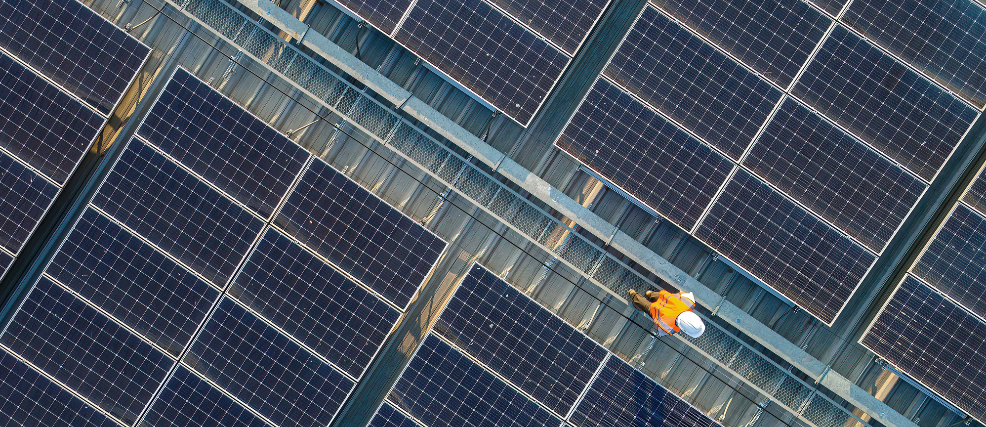 Aerial view of Engineers working at solar panels roof
